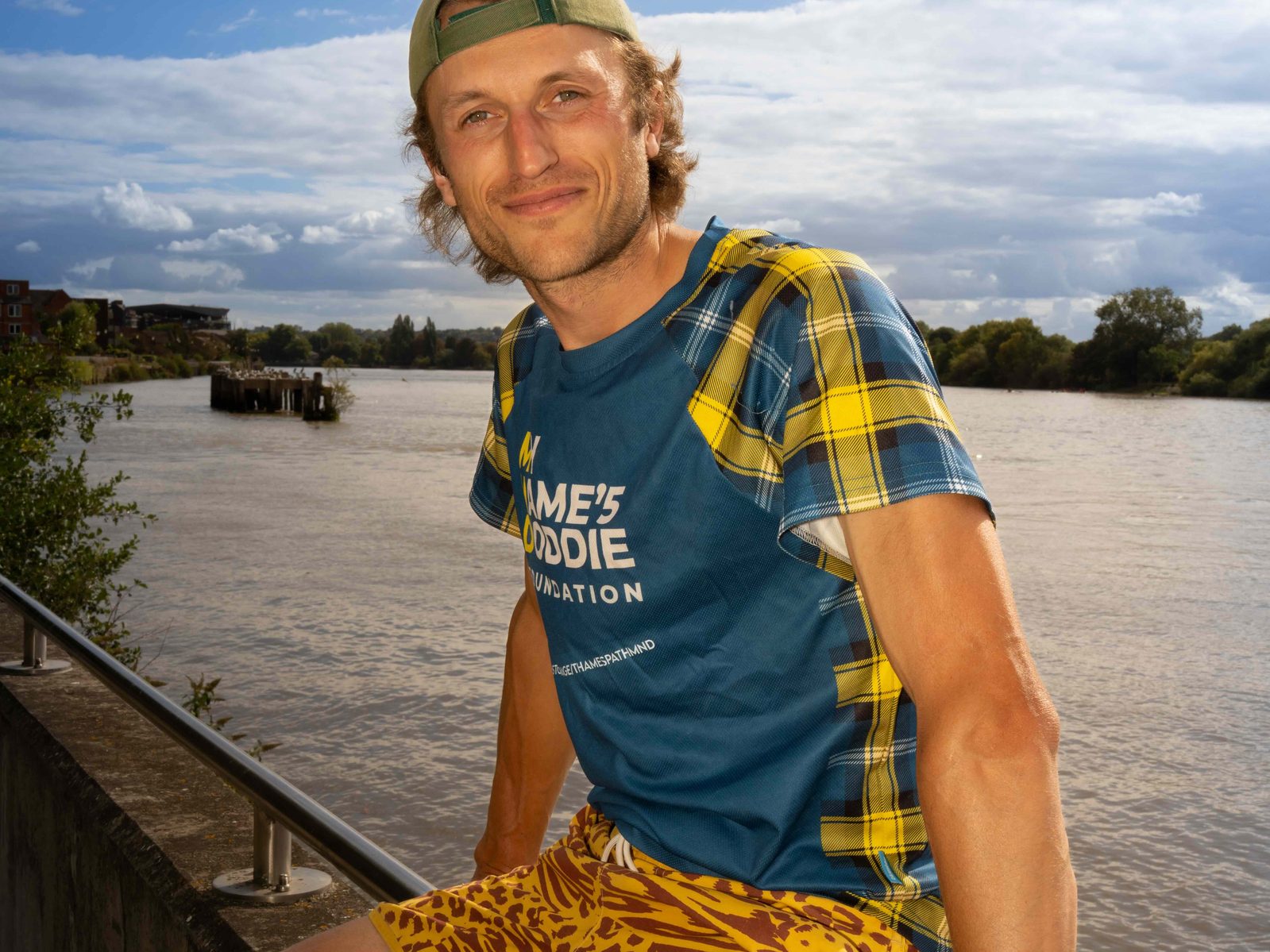 Tom sitting on the river wall at Hammersmith
